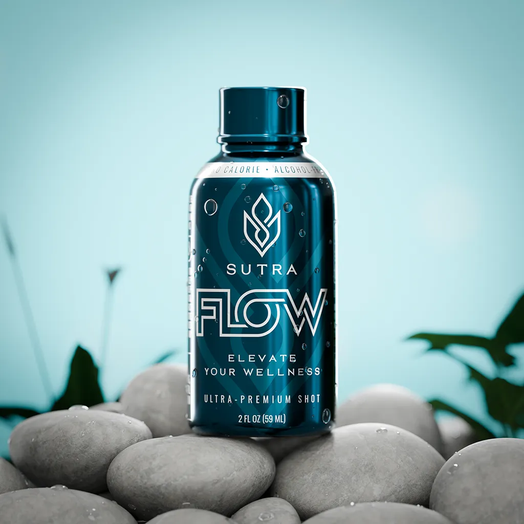 A teal bottle of Sutra Flow ultra-premium wellness shot covered in water droplets, resting on smooth grey river stones against a clean light blue backdrop.